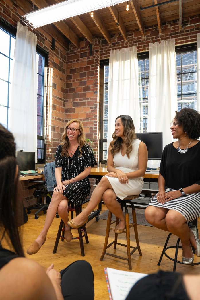 Women business owners meeting together in a sunlit studio